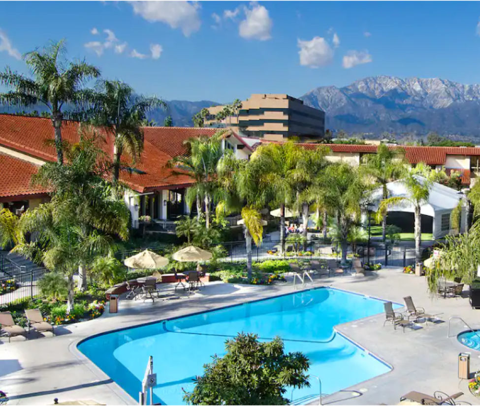 Aerial image of the Hilton Doubletree Hotel's Pool set in front of a mountain backdrop